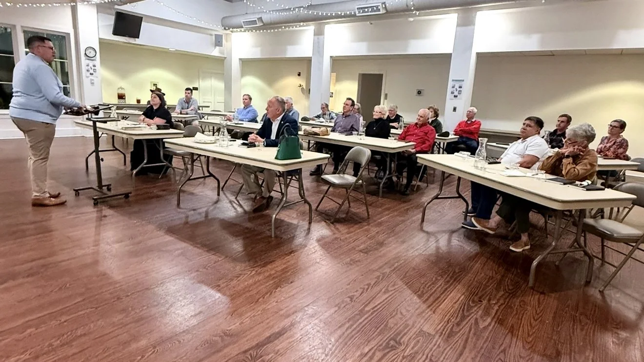 The interior of Skardon Hall: long tables and folding chairs set out across the floor of the aging fellowship space.